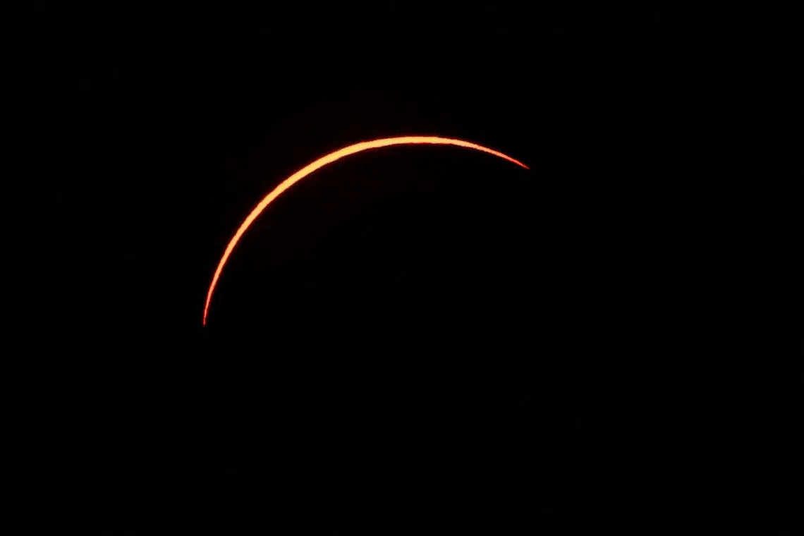 The Moon partially covers the Sun before the total solar eclipse as seen from La Zurriola beach in San Sebastian, on August 12, 2026. Millions of Europeans contemplated the sky in awe today during a rare total solar eclipse that will plunge a swathe of Spain into an eerie daytime darkness. The shadow cast when the Moon covers the Sun began in Russia's remote Arctic north at around 1700 GMT and continued in an arc through Greenland and Iceland. Spain is where most people viewed the total eclipse, which crossed the country diagonally from the northern Atlantic coast to the Mediterranean Sea, where it vanished at around 1830 GMT. (Photo by Thomas COEX / AFP)