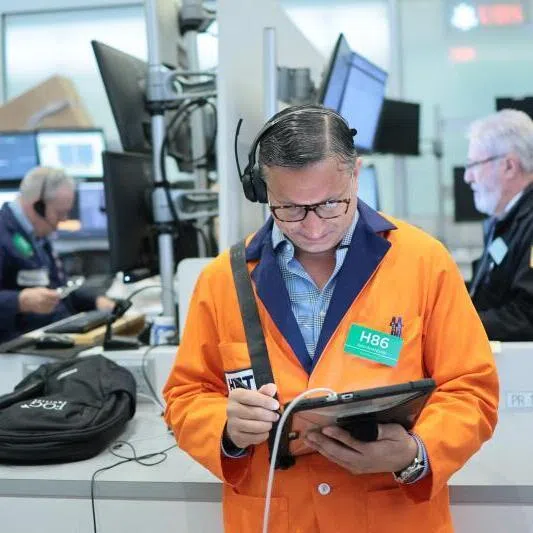 Traders work on the floor of the New York Stock Exchange during morning trading on June 15, 2026 in New York City. 