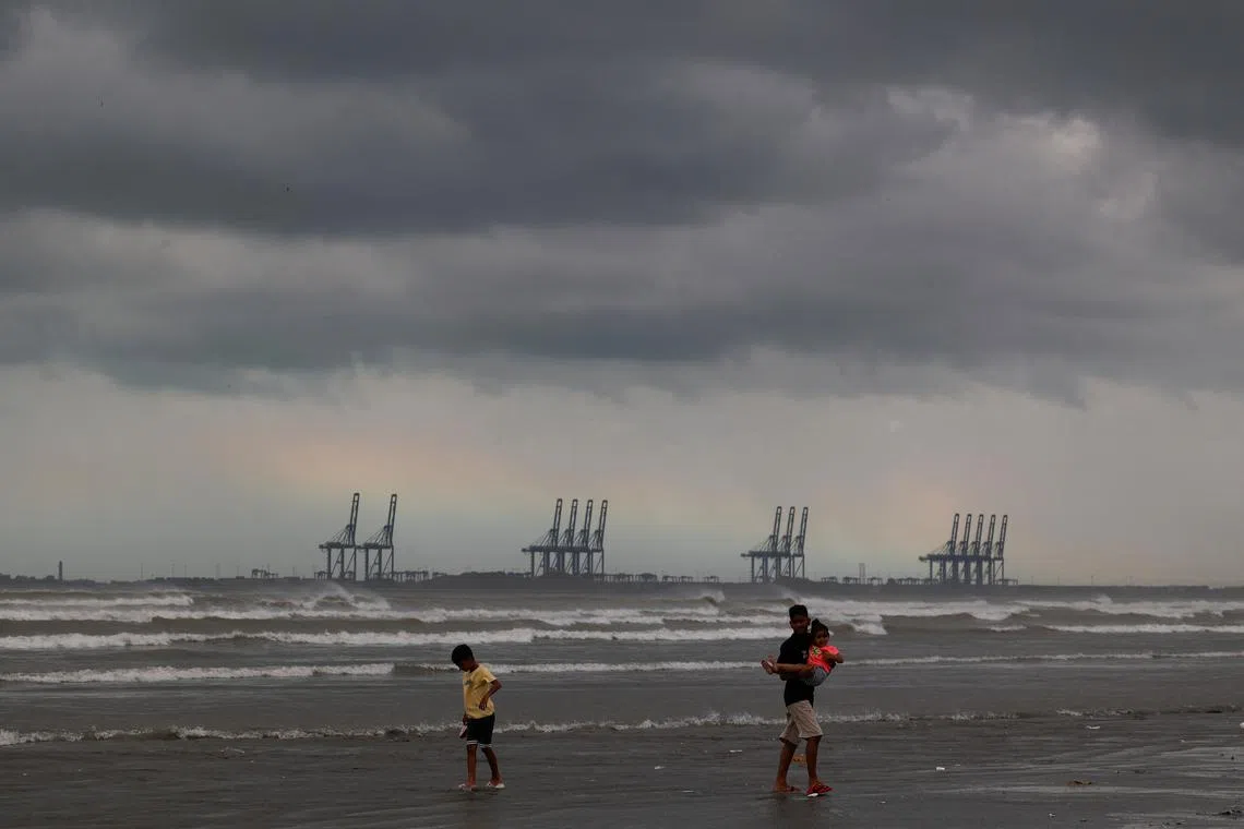 Children play, with the rainbow and rain clouds in the background, as according to the Pakistan Meteorological Department a potential cyclonic storm could develop over the Arabian Sea, at Clifton Beach in Karachi, Pakistan August 30, 2024. REUTERS/Akhtar Soomro