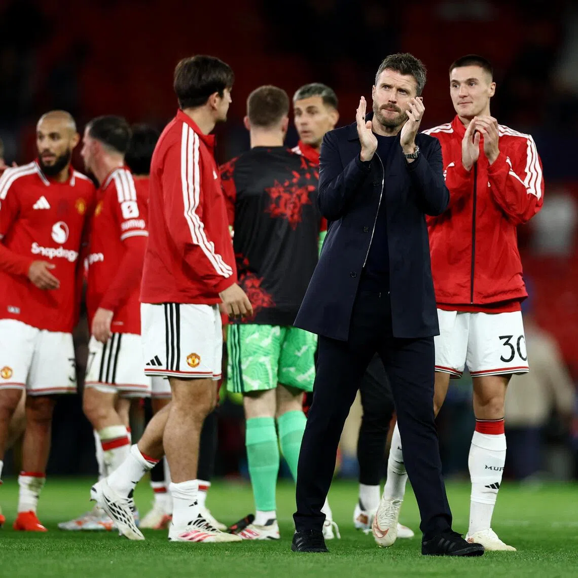 Manchester United manager Michael Carrick applauding fans after his team’s 4-0 Champions League thrashing of Azerbaijani minnows Sabah at Old Trafford on Sept 10.
