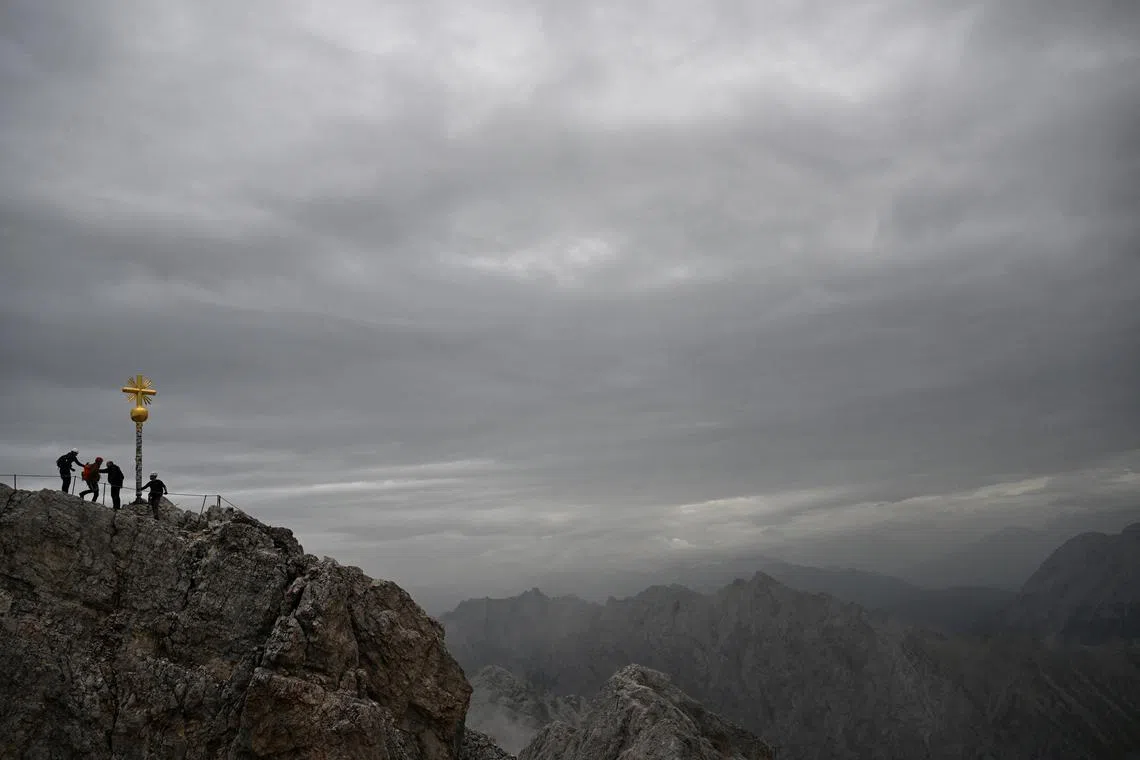 Mountaineers walking on Germany's highest peak, the Zugspitze mountain near Garmisch-Partenkirchen, Germany, Sept 18.