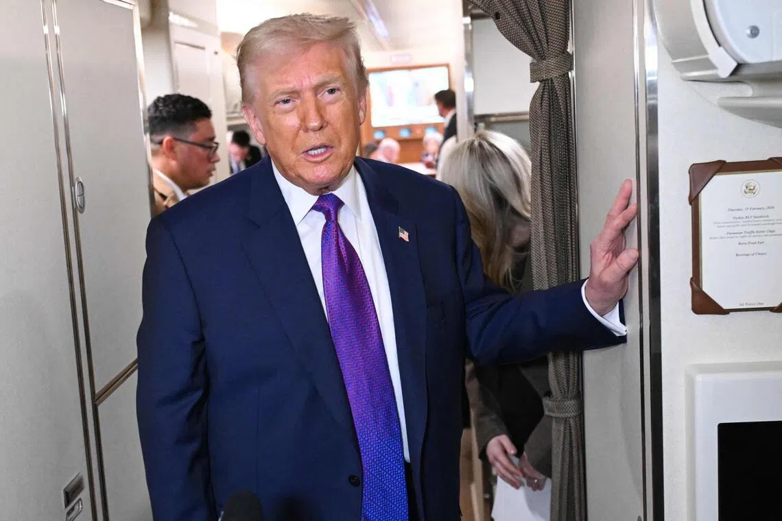 US President Donald Trump speaking to reporters aboard Air Force One on Feb 19, before heading to the US state of Georgia.