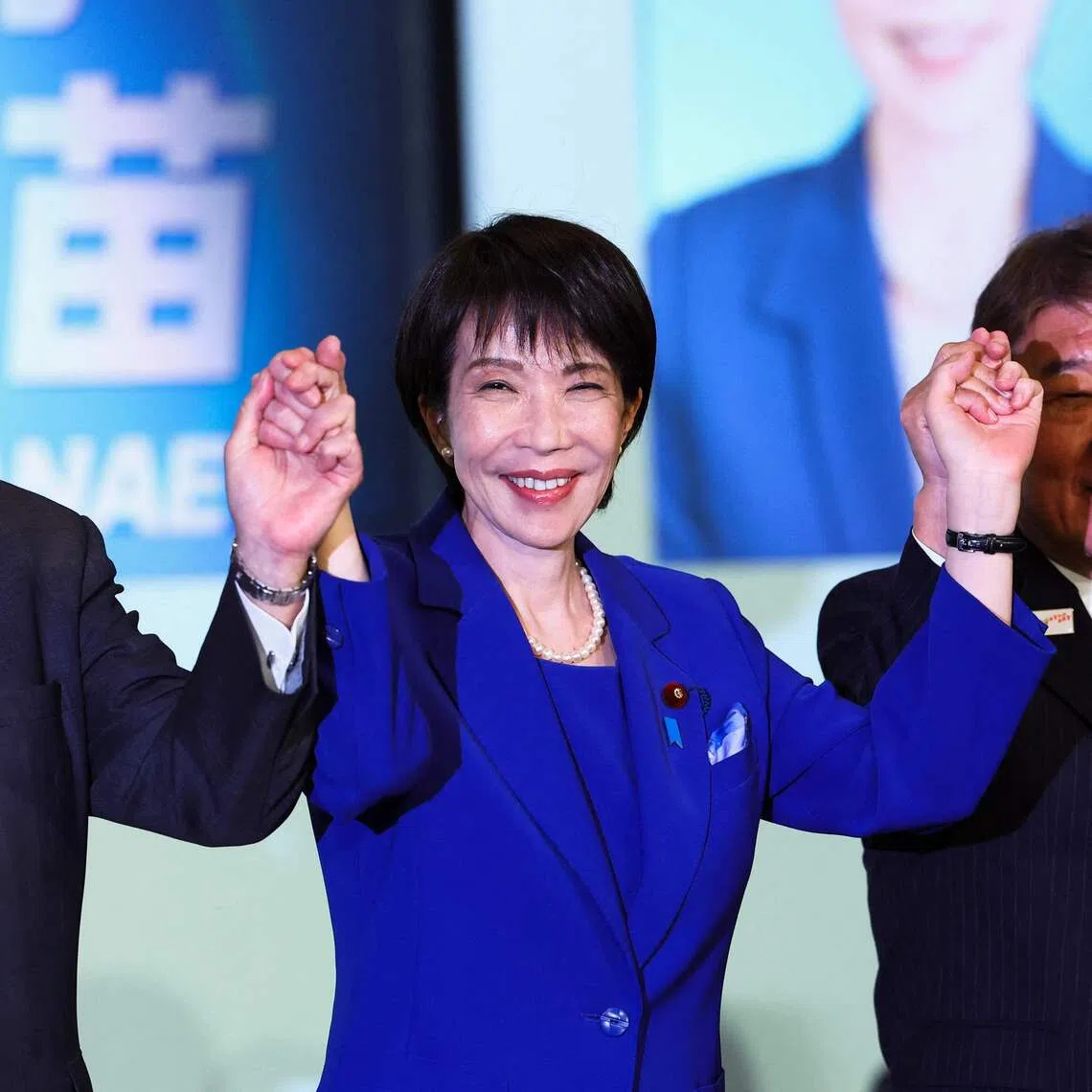 Newly elected leader of Japan's Liberal Democratic Party Sanae Takaichi celebrating her election win with Prime Minister Shigeru Ishiba in Tokyo on Oct 4.