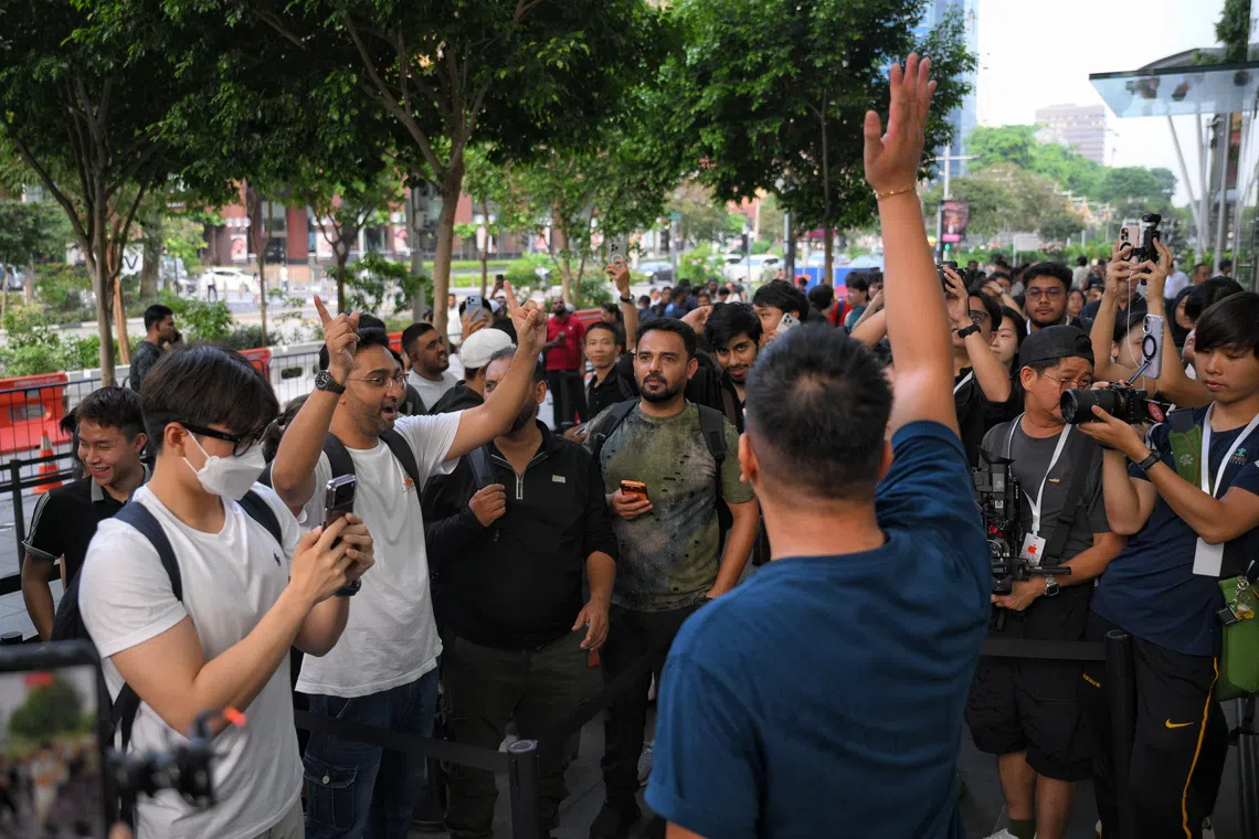 First in line in the walk-in queue at Apple’s flagship Orchard Road store was Adnan Mehta (second from left), who had been waiting outside the store since 5.30am on Oct 22.