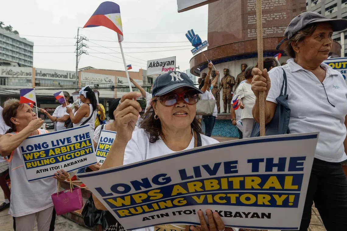 epa11473695 Protesters hold signs defending Philippine sovereignty in areas of the South China Sea, or locally referred to as West Philippine Sea, during a rally in Quezon City, Metro Manila, Philippines, 12 July 2024. Demonstrators marked the 8th anniversary of an international arbitral ruling made on 12 July 2016 from The Hague, Netherlands that favored Philippine sovereignty over its exclusive economic zones in disputed waters of the South China Sea and denied China's nine-dash-line claim.  EPA-EFE/ROLEX DELA PENA