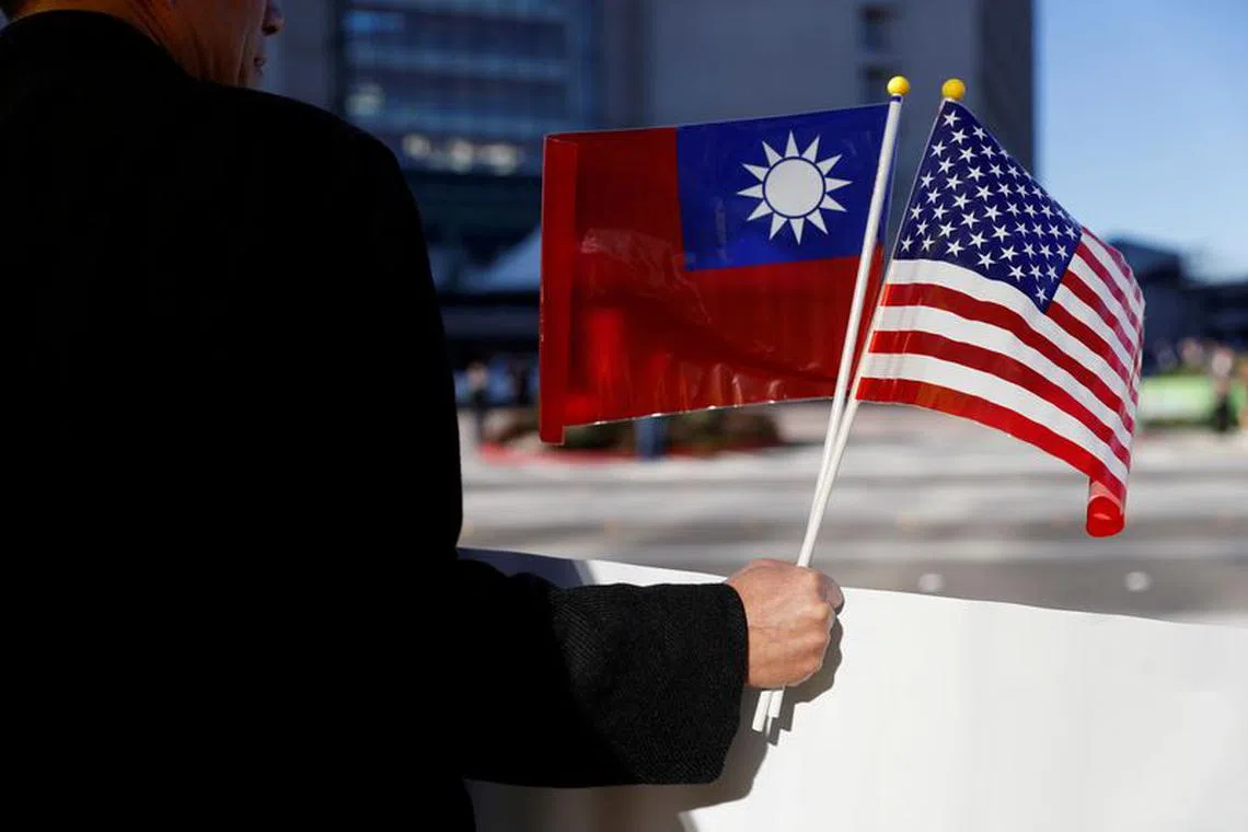 A demonstrator holds flags of Taiwan and the United States in support of Taiwanese President Tsai Ing-wen during an stop-over after her visit to Latin America in Burlingame, California, U.S., January 14, 2017. REUTERS/Stephen Lam/File Photo