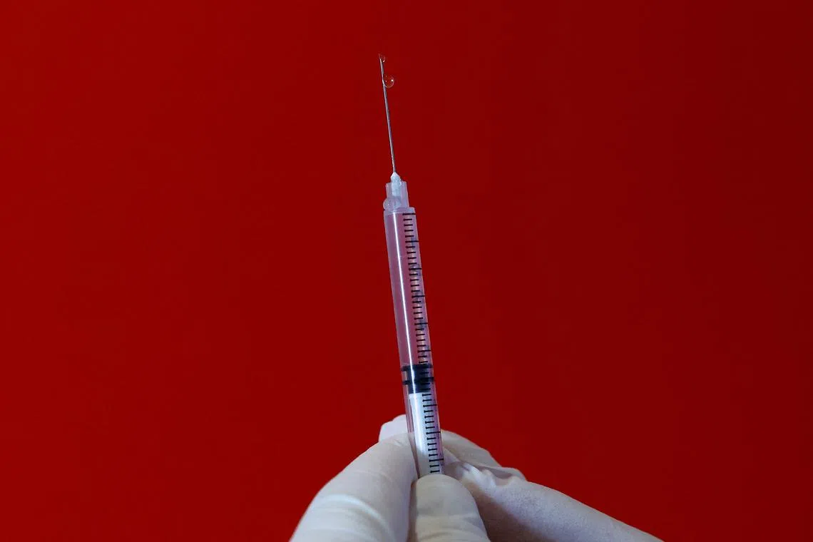 FILE PHOTO: A medical worker holds a syringe with the mpox vaccine at a vaccination center in Nice, France, July 27, 2022.  REUTERS/Eric Gaillard/File Photo