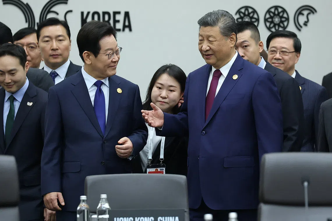China's President Xi Jinping talks with South Korea's President Lee Jae Myung during the Asia-Pacific Economic Cooperation (APEC) summit in Gyeongju, South Korea, October 31, 2025.   Yonhap via REUTERS