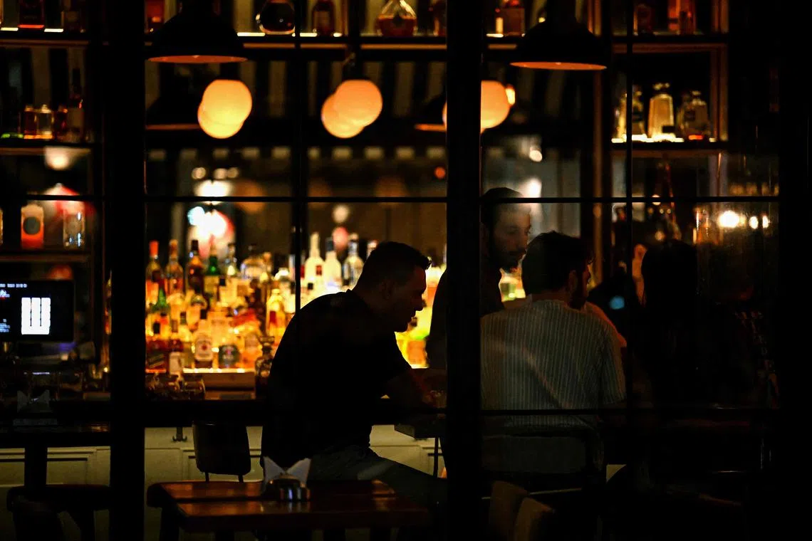 Revelers drink at a pub in Beirut's Mar Mikhail neighbourhood on June 22, 2024.