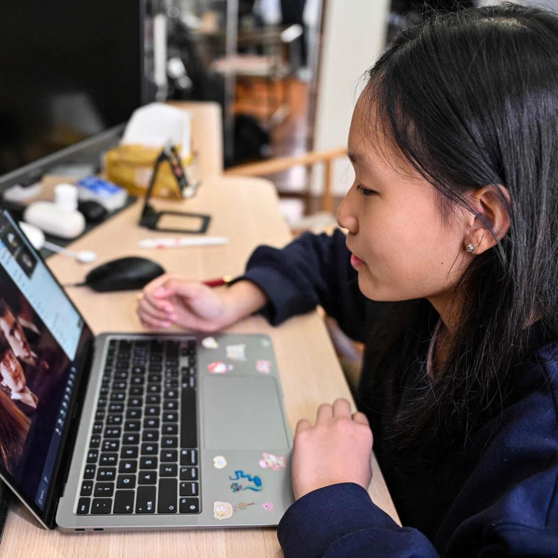 Estella, 14, a homeschooled student, attends a Spanish class in her home in Shanghai.