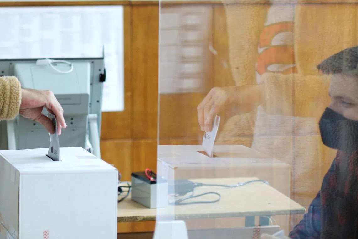 FILE PHOTO: A person casts vote at a polling station, during parliamentary and presidential elections, in Sofia, Bulgaria, November 14, 2021. REUTERS/Spasiyana Sergieva/File Photo