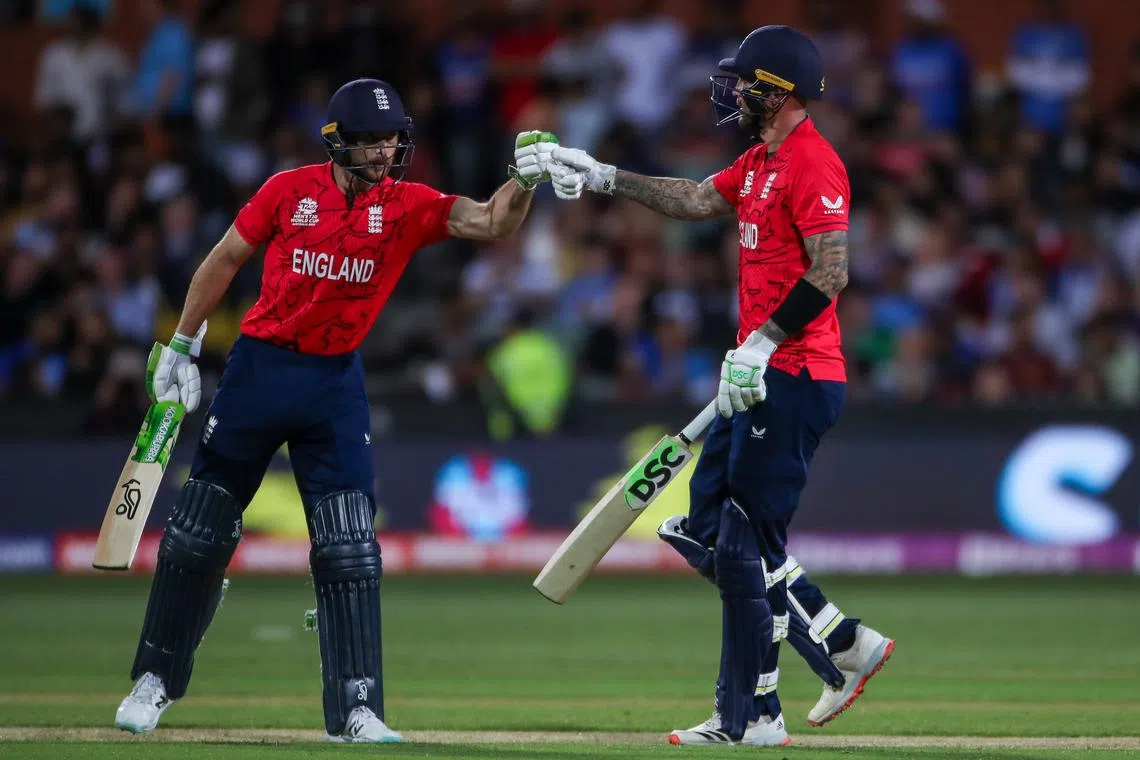 England's batsmen Jos Buttler (left) and Alex Hales celebrate following England's win in the T20 World Cup semi-final match between India and England at Adelaide Oval on Nov 10, 2022.