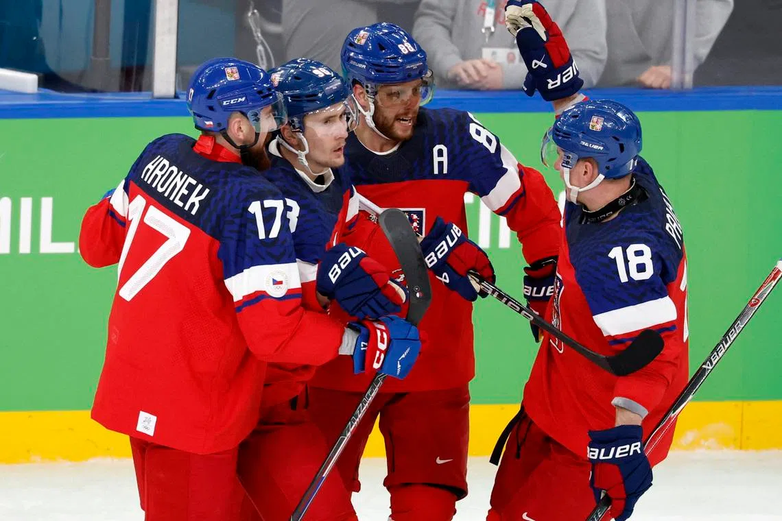 Milano Cortina 2026 Olympics - Ice Hockey - Men's Qualification Play-off - Czech Republic vs Denmark - Milano Santagiulia Ice Hockey Arena, Milan, Italy - February 17, 2026. Martin Necas of Czech Republic celebrates with Ondrej Palat of Czech Republic and Filip Hronek of Czech Republic after scoring their first goal REUTERS/David W Cerny