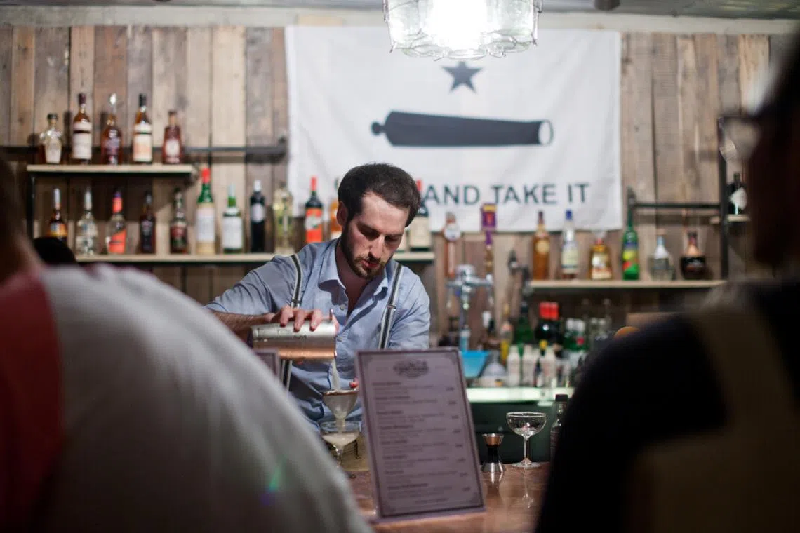 American Philip Abowd, owner of Southside Parlour, mixes a drink at his cocktail bar and restaurant located in Gyeongridan, Itaewon.