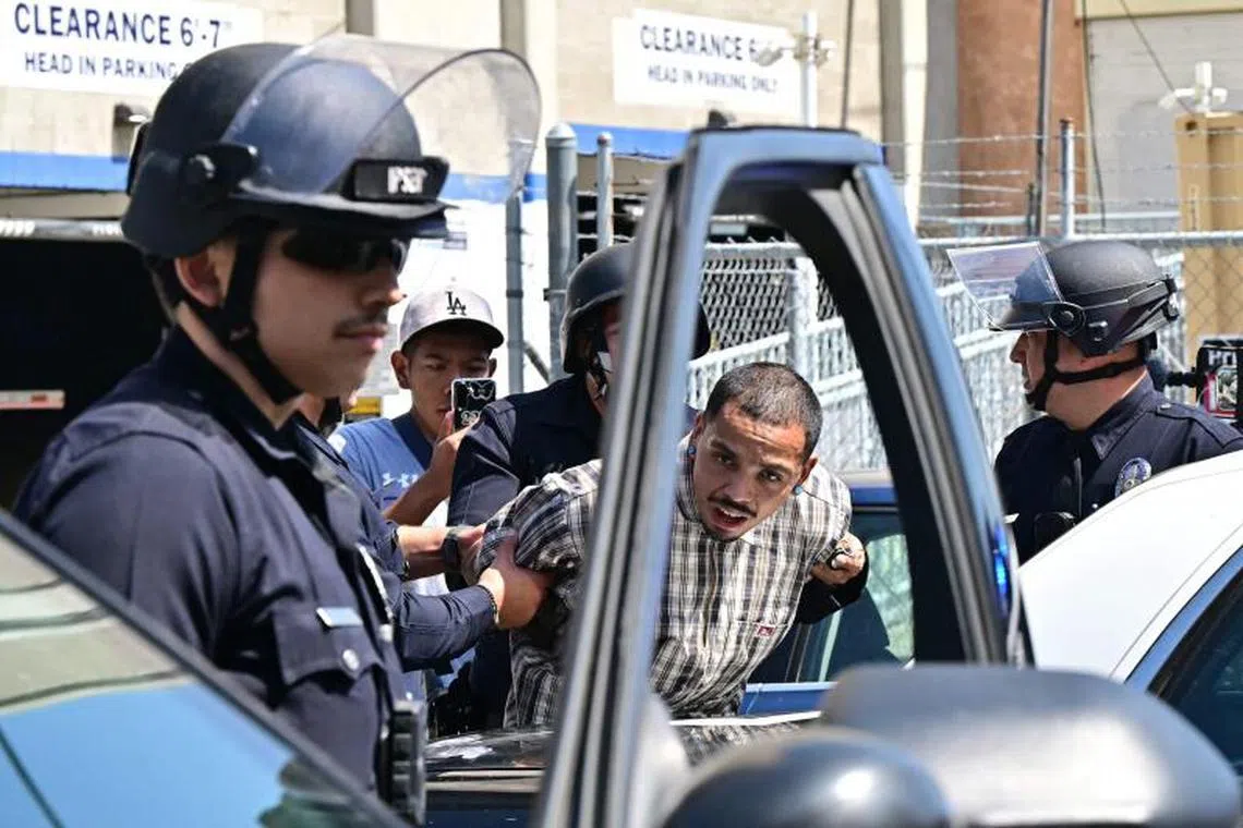 A man detained by the police during a protest in downtown Los Angeles, on June 8, 2025.