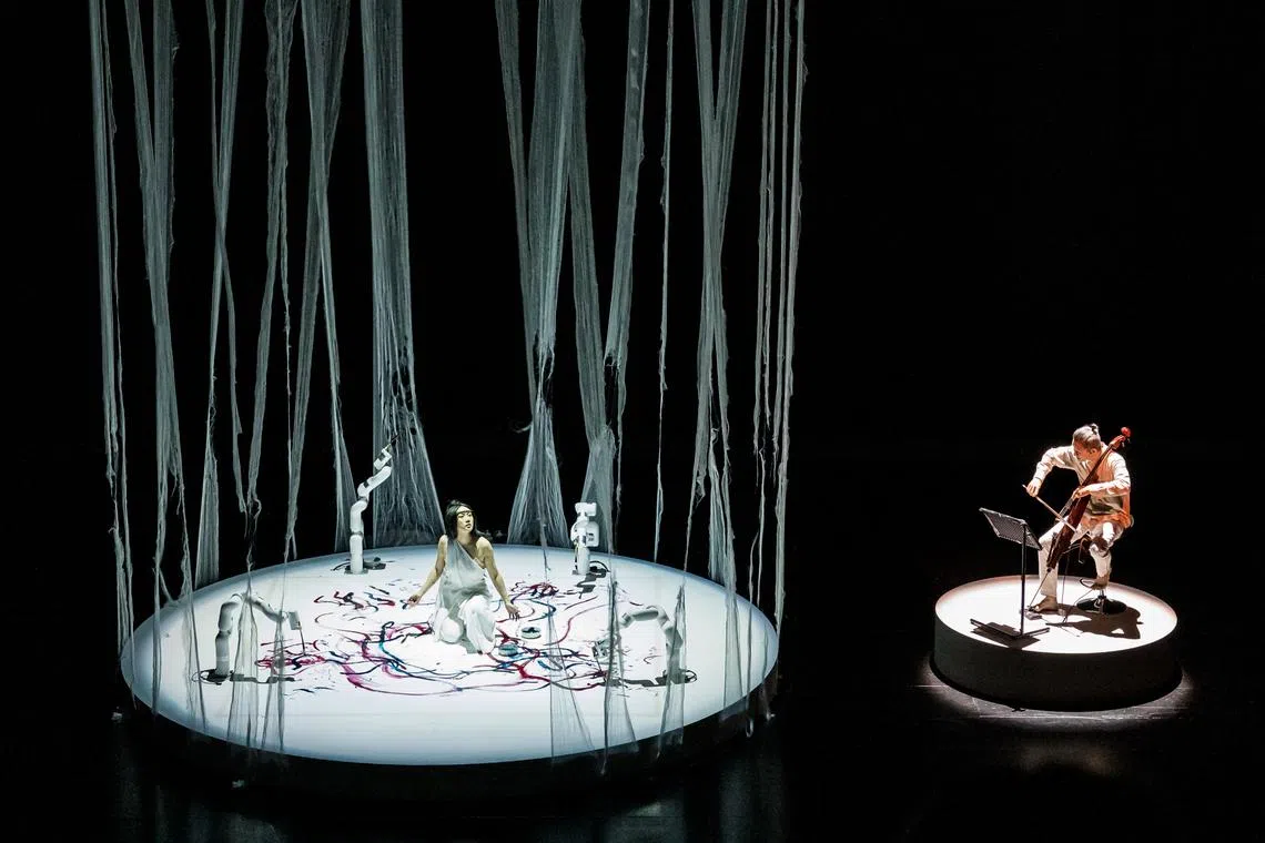 (From left) Canadian artist Sougwen Chen and Singaporean cellist Leslie Tan perform Realm Of Silk at the Singapore International Festival of Arts (Sifa) 2023. 