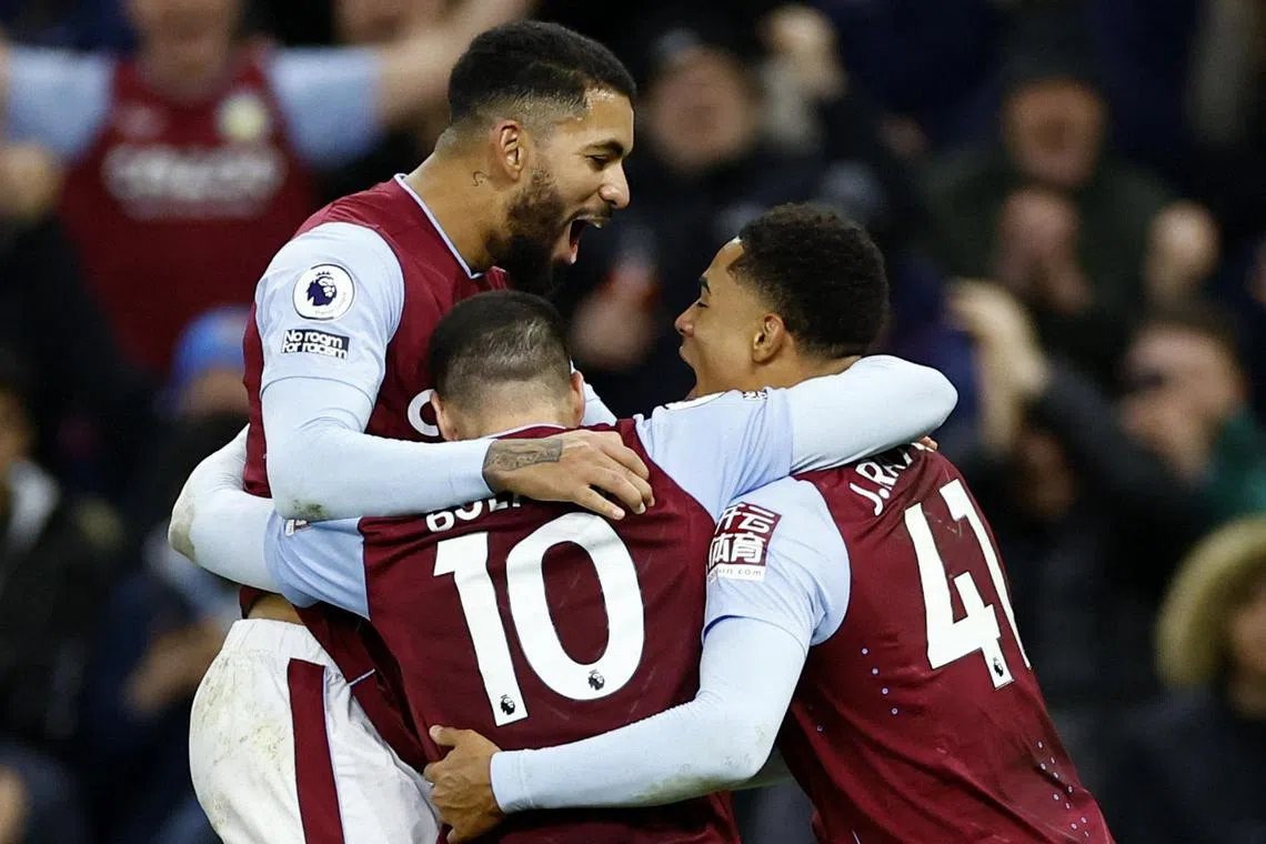 Aston Villa's Emiliano Buendia celebrates scoring their second goal with Douglas Luiz and Jacob Ramsey.