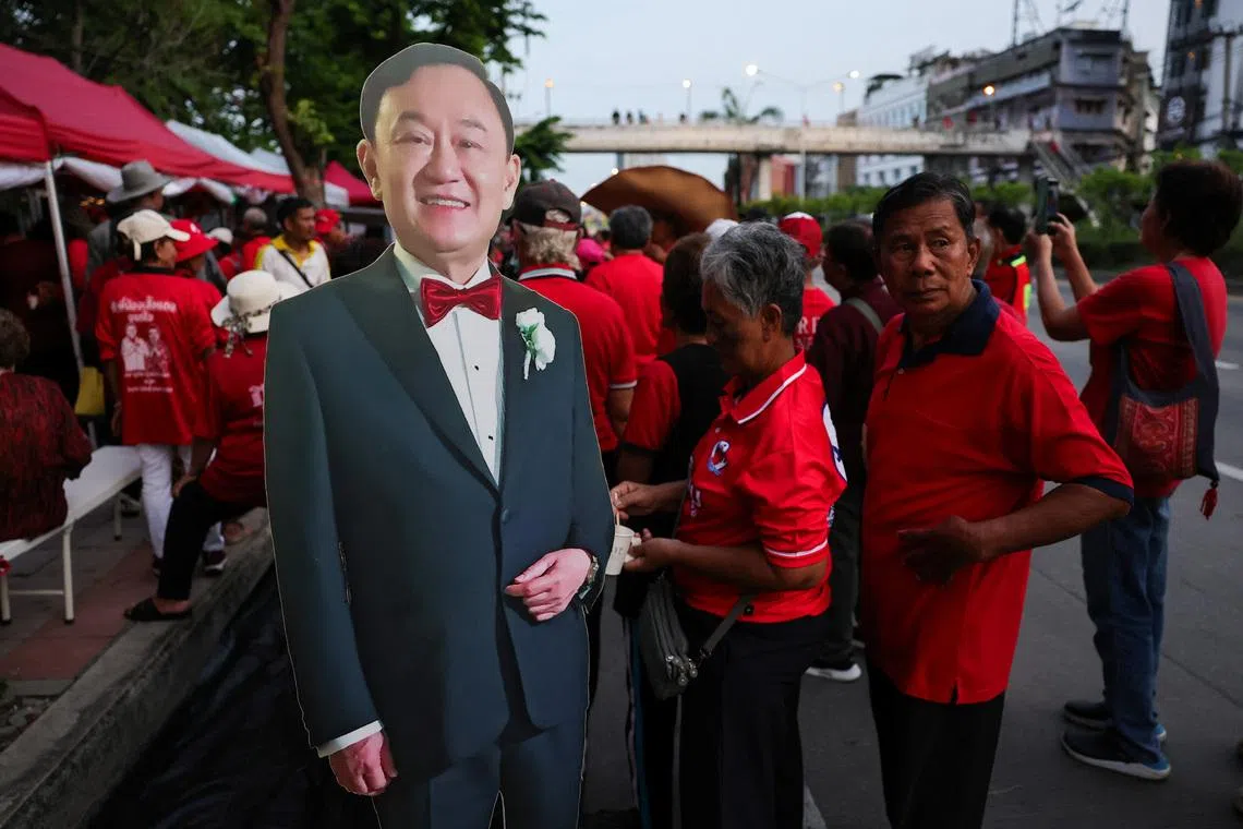 Supporters of former Thai Prime Minister Thaksin Shinawatra wait for his release on parole at Klong Prem Central Prison, in Bangkok, Thailand, on May 11.