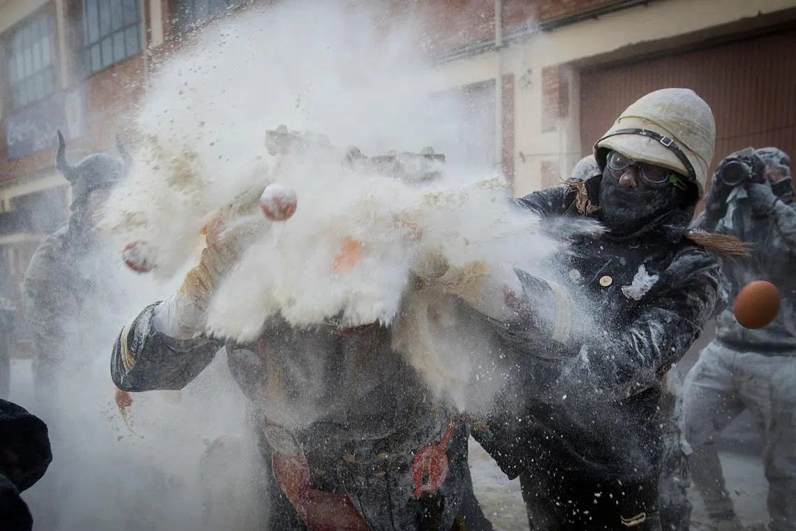 Revellers dressed in mock military garb taking part in the "Els Enfarinats" battle in the southeastern Spanish town of Ibi on Dec 28, 2023. 