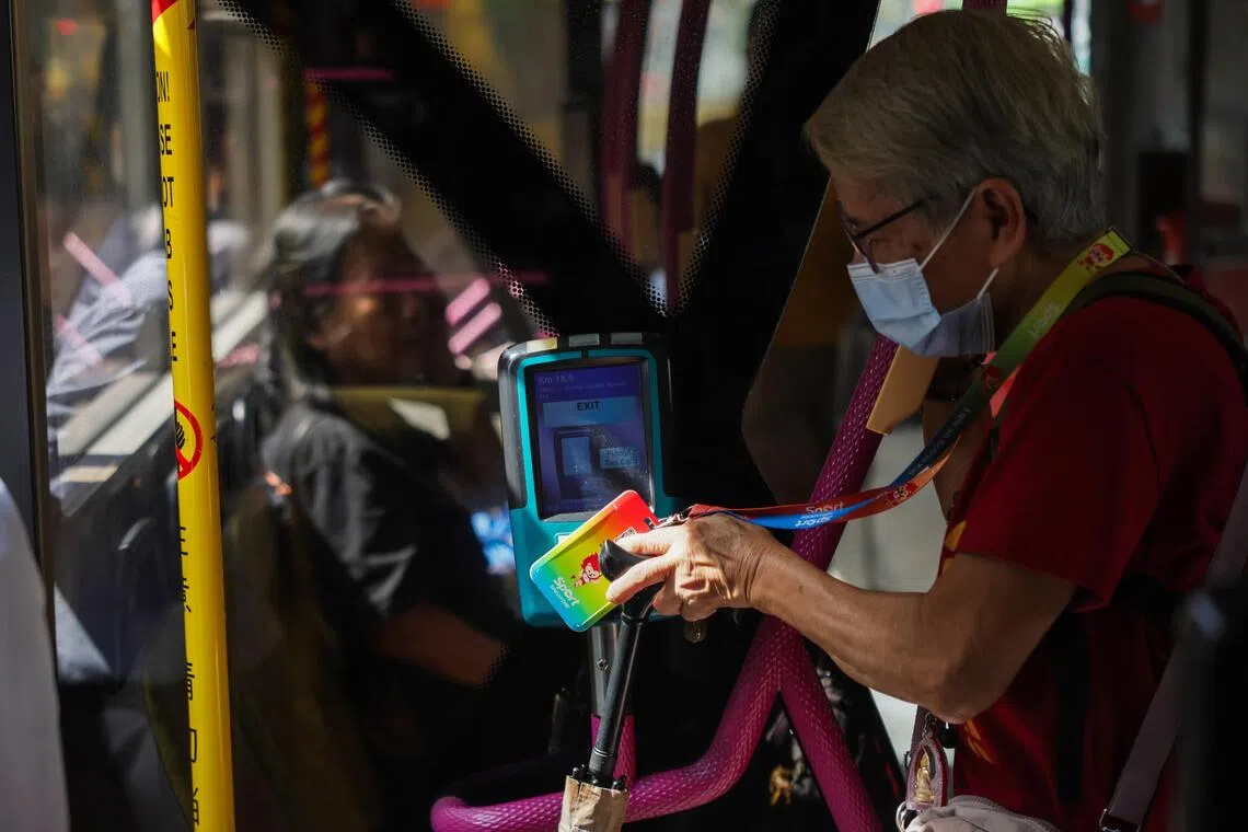 ST20251014_202510800698: Gin Tay/ ntexpress14/Lee Nian Tjoe/Commuters tapping out of the card reader as they alight the bus on Oct 14, 2025.Can use for stories on public transportation, fare hike, bus, SMRT, commuters, petrol, diesel, electricity, SimplyGo, digital payment, EZlink card, 