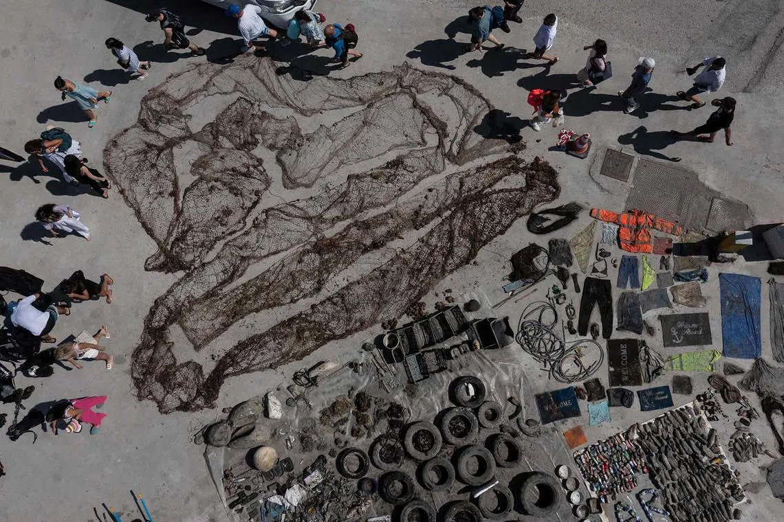 This aerial photograph taken on June 4 shows marine litter collected by the NGO Aegean Rebreath displayed at the port of Vlychada on the island of Santorini, Greece.