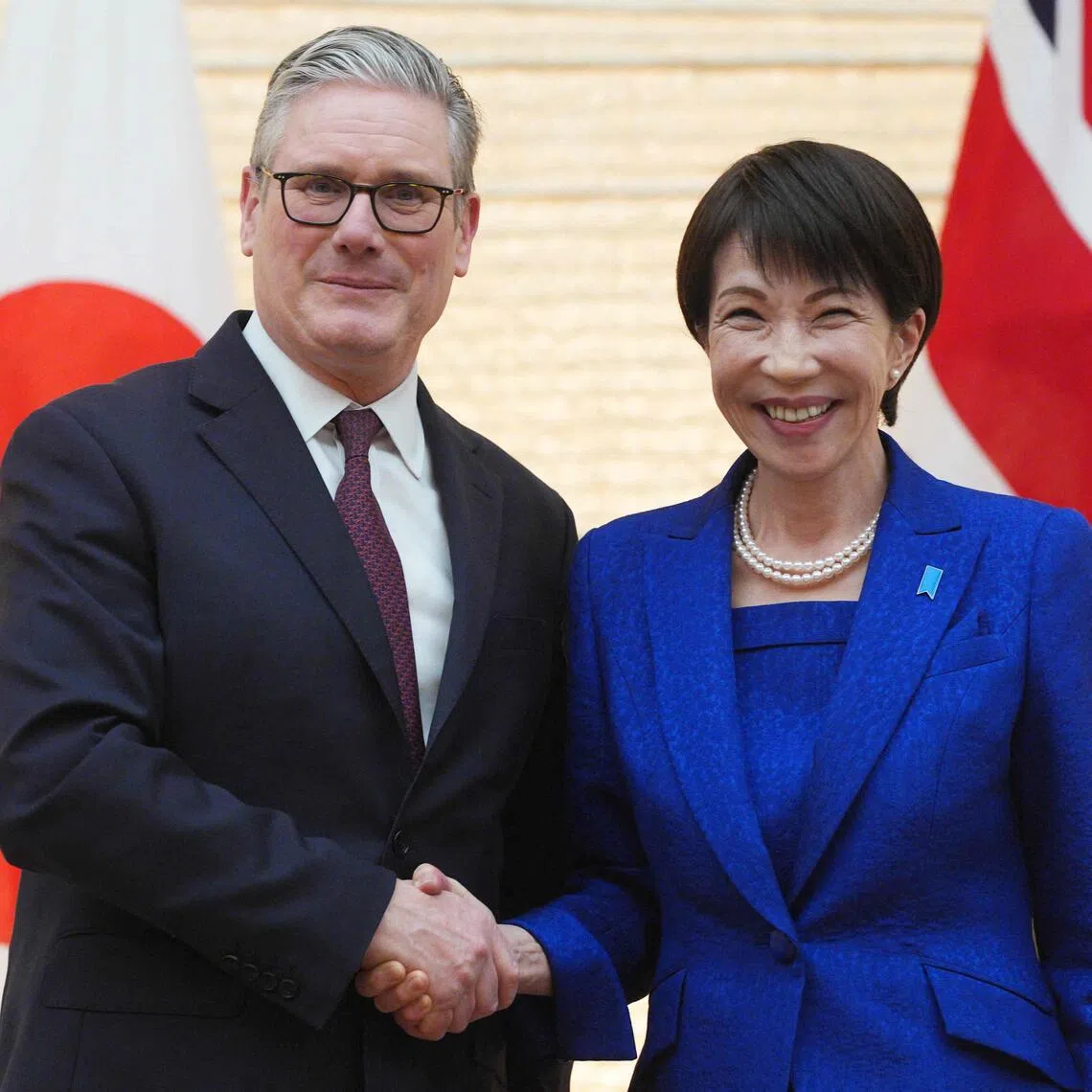 British Prime Minister Keir Starmer (L) and Japanese Prime Minister Sanae Takaichi shake hands after their joint press conference following their bilateral meeting at the Prime Minister's Office in Tokyo on January 31, 2026. (Photo by Carl Court / POOL / AFP)