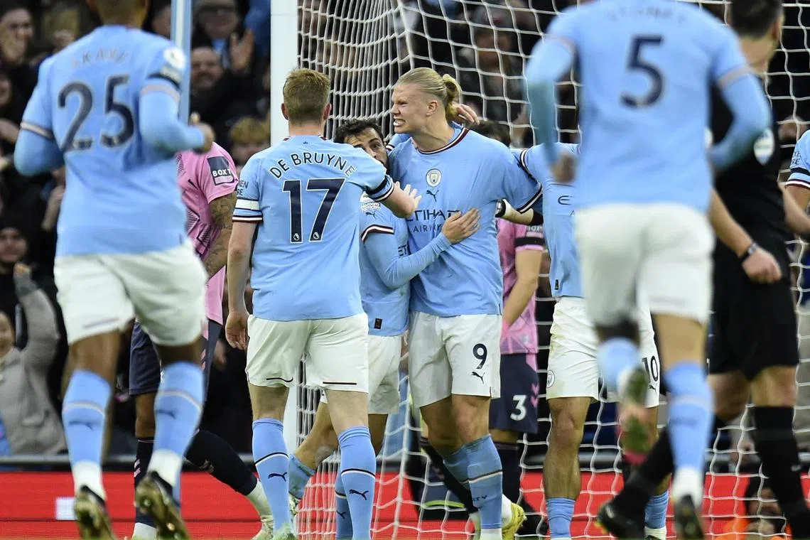 Erling Haaland (centre) celebrates with teammates after scoring for City.