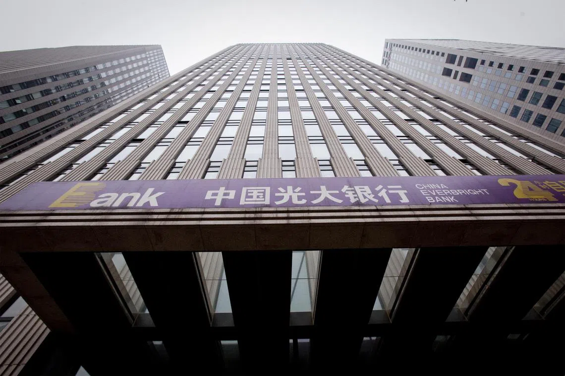 Signage for China Everbright Bank hangs outside a branch in Beijing.