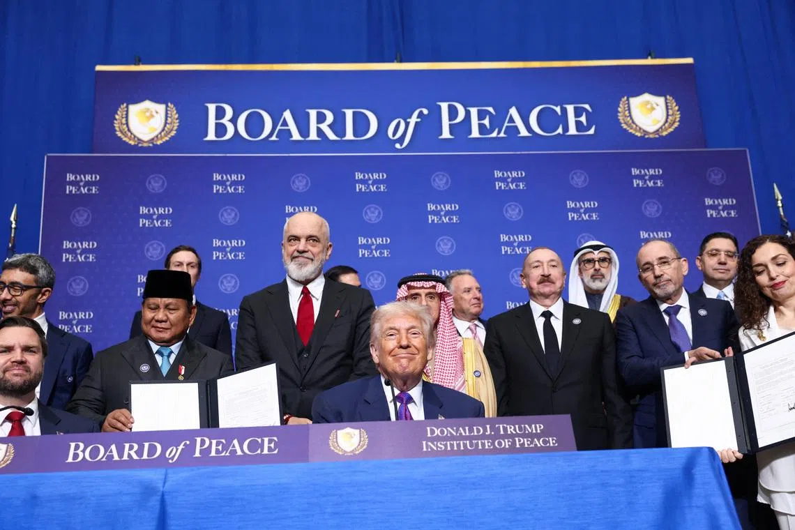 U.S President Donald Trump, Vice President JD Vance, Albania's Prime Minister Edi Rama,  Saudi Minister of State for Foreign Affairs, Cabinet Member, and Climate Envoy Adel Al-Jubeir, Azerbaijani President Ilham Aliyev, and Jordan's Foreign Minister Ayman Safadi present signed documents of the declaration of the funding donors to the Board of Peace, during the inaugural Board of Peace meeting at the U.S. Institute of Peace in Washington, D.C., U.S., February 19, 2026. REUTERS/Kevin Lamarque