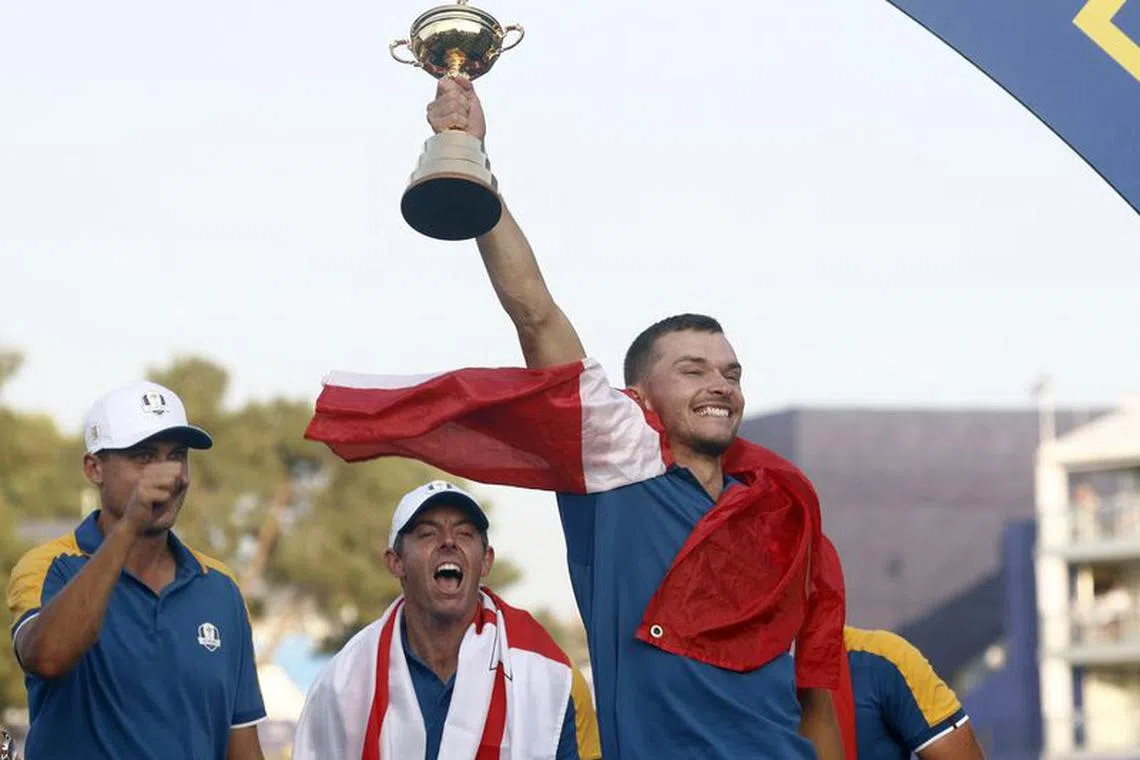 Golf - The 2023 Ryder Cup - Marco Simone Golf & Country Club, Rome, Italy - October 1, 2023 Team Europe's Nicolai Hojgaard holds the trophy aloft as he celebrates with Rory McIlroy and Ludvig Aberg during the presentation after winning the Ryder Cup REUTERS/Guglielmo Mangiapane/ File Photo