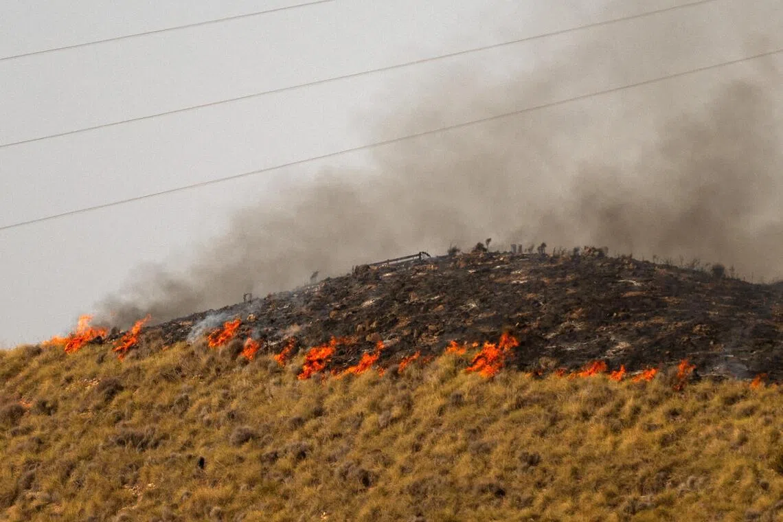 Flames stretching along a hillside are pictured in the area of a wildfire that killed at least 12 people near Bedar, in Los Gallardos district, in Almeria Province, on July 11.