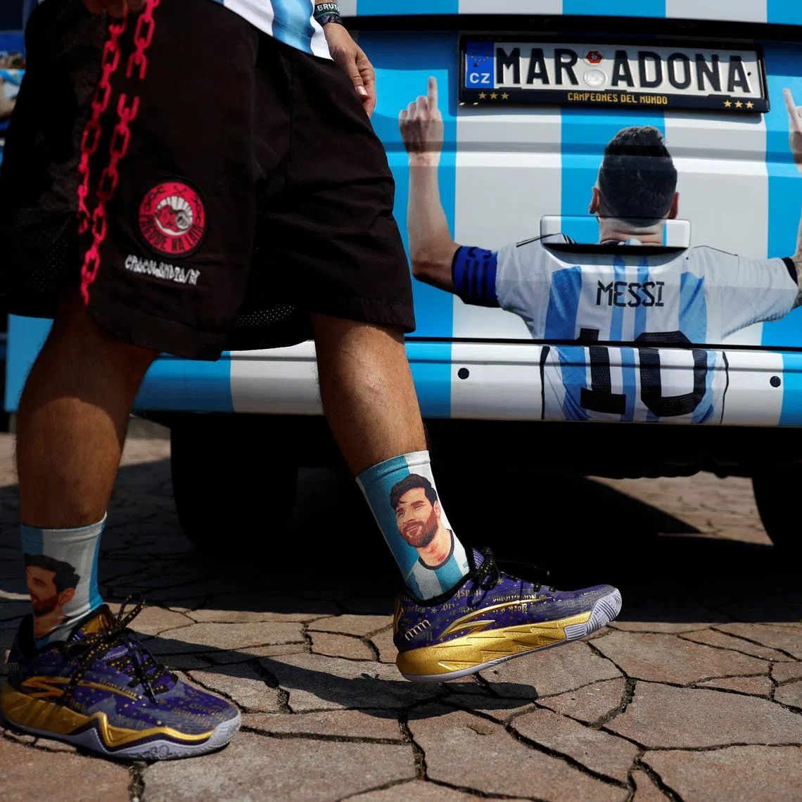 Miloslav \"Curby\" Urbanec, a 51-year-old Czech national and an ardent Argentine football fan, wears Lionel Messi themed socks as he walks past his car in front of of his house, in the village of Bukovka near the town of Lazne Bohdanec, Czech Republic, June 29, 2026. REUTERS/David W Cerny