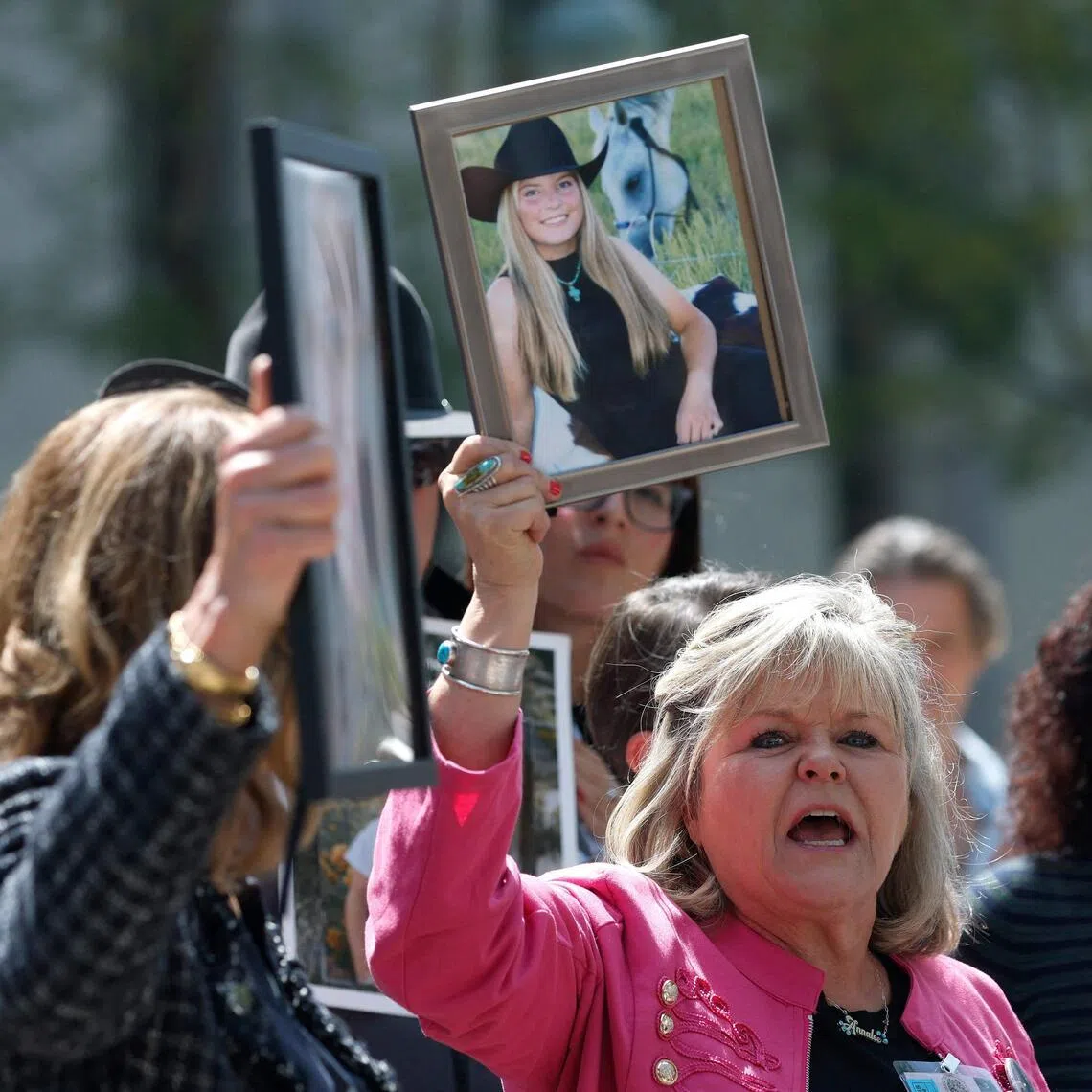 Ms Lori Schott, a plaintiff who has filed a lawsuit against social media companies for the death of her daughter, holding a photo as she speaks to reporters outside of the Los Angeles Superior Court on March 25.