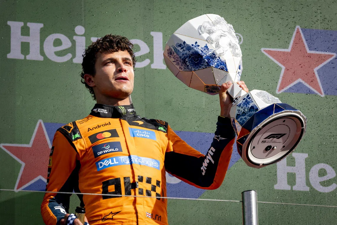 First placed McLaren driver Lando Norris of Britain poses with the trophy on the podium after the Formula 1 Dutch Grand Prix at the Circuit Zandvoort racetrack in Zandvoort, Netherlands.