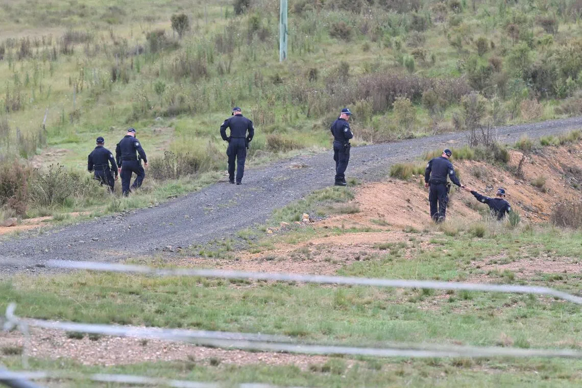 Police conduct a line search on a rural property on Hazelton Road, Bungonia, in New South Wale's Southern Tablelands on Feb 26, 2024.