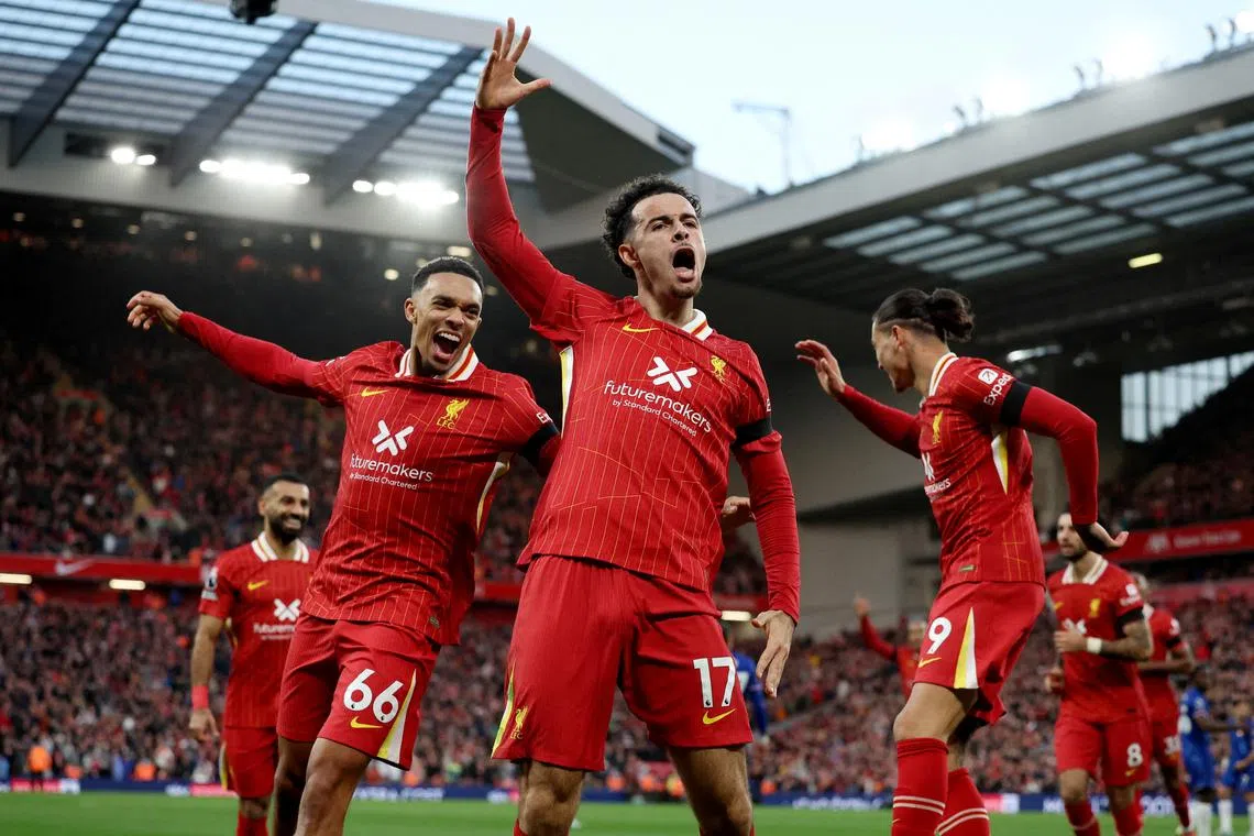 Liverpool's Curtis Jones celebrates scoring their second goal with Trent Alexander-Arnold and Darwin Nunez.