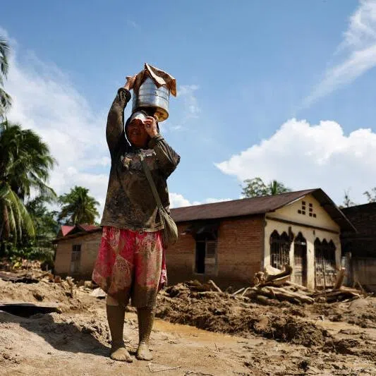 Survivor Helen Simare-mare, 48, stands at an area affected by a deadly flash flood in Batang Toru, South Tapanuli, North Sumatra province, Indonesia, December 6, 2025. PHOTO: REUTERS/Willy Kurniawan