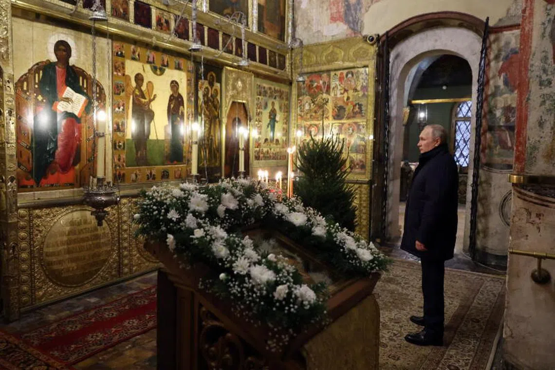 Russian President Vladimir Putin attends a Christmas service at the Annunciation Cathedral in Moscow, Russia, on Jan 6, 2023.