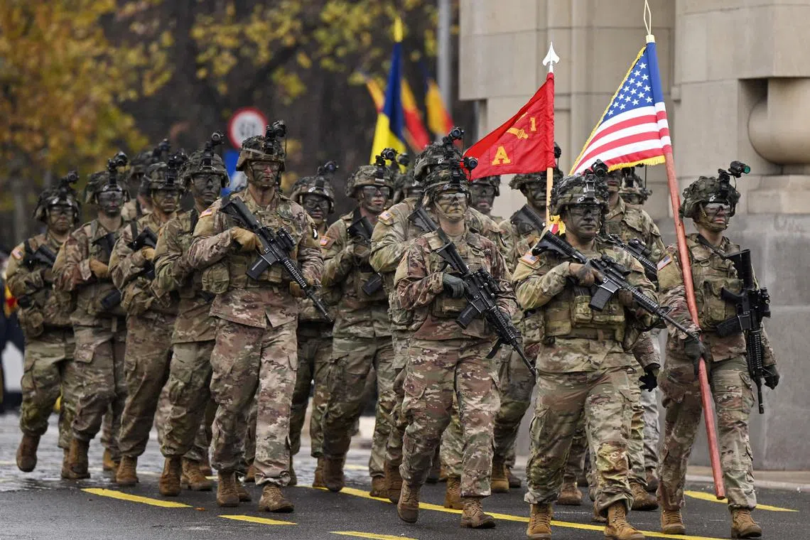 US army troops march during the military parade on Romania's National Day in Bucharest, on Dec 1, 2022.