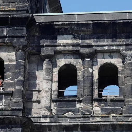 A man dressed as a Roman soldier is seen in one of the windows of Porta Nigra, former Roman city gate, in Trier, Germany.