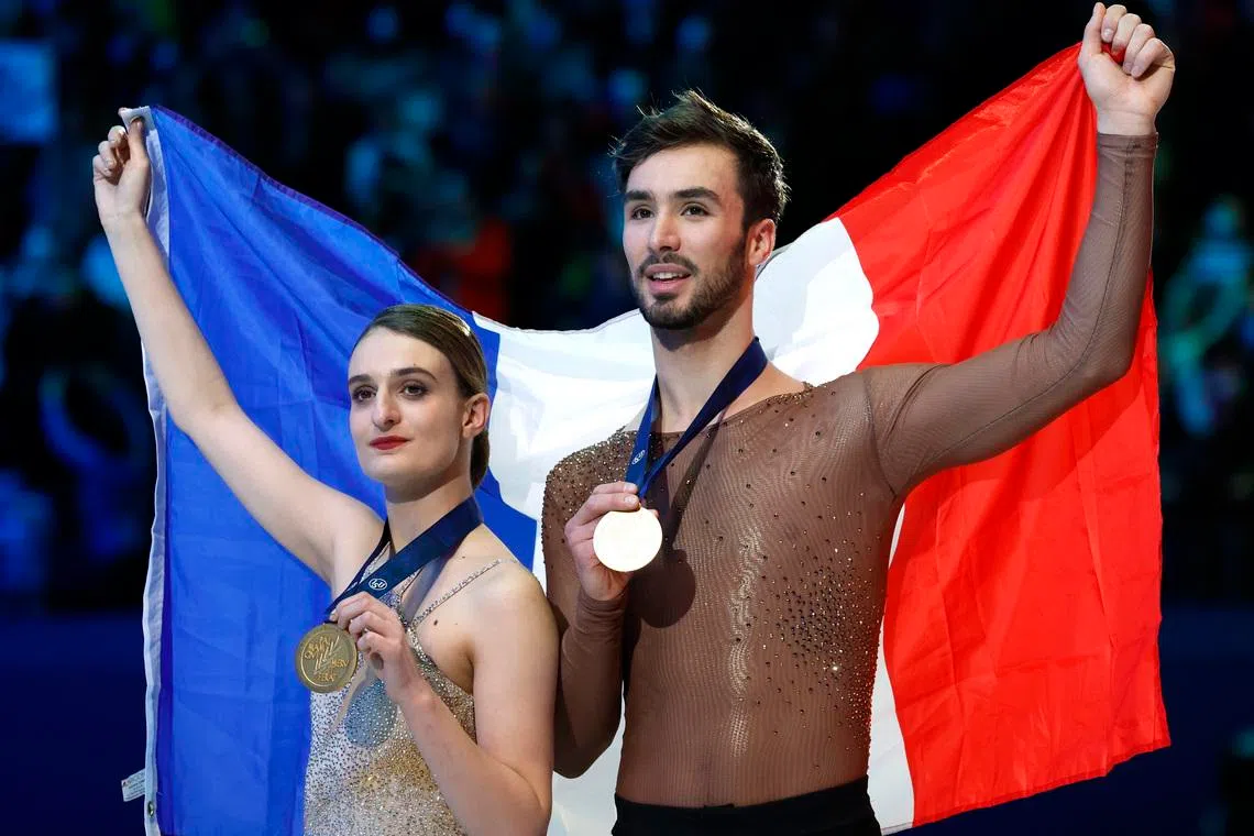 Figure Skating - World Figure Skating Championships - South of France Arena, Montpellier, France - March 26, 2022 France's Gabriella Papadakis and Guillaume Cizeron celebrate winning the Ice Dance with their medals REUTERS/Juan Medina