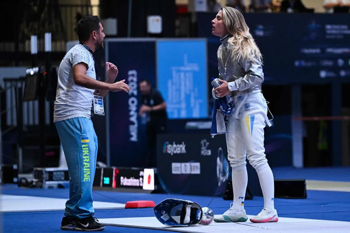 Ukraine's Olga Kharlan (right) speaks with her coach during her qualifier against Russia's Anna Smirnova.
