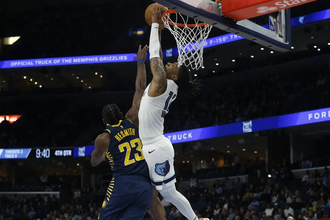 Memphis Grizzlies guard Ja Morant attempting a dunk as Indiana Pacers forward Aaron Nesmith fouls him during the second half at FedExForum. Morant scored 27 points, pulled down 10 rebounds and handed out 15 assists in Memphis' 112-110 home win.