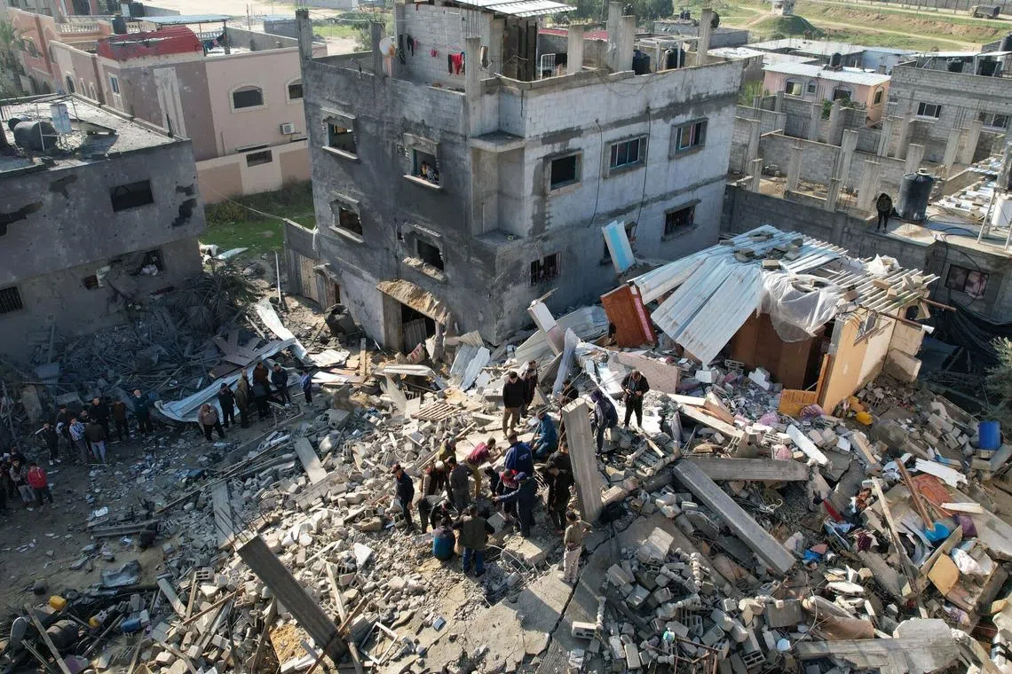 Residents search the rubble of a destroyed building in the aftermath of an Israeli airstrike in the Yabna refugee camp in Rafah, southern Gaza, on Dec 14.