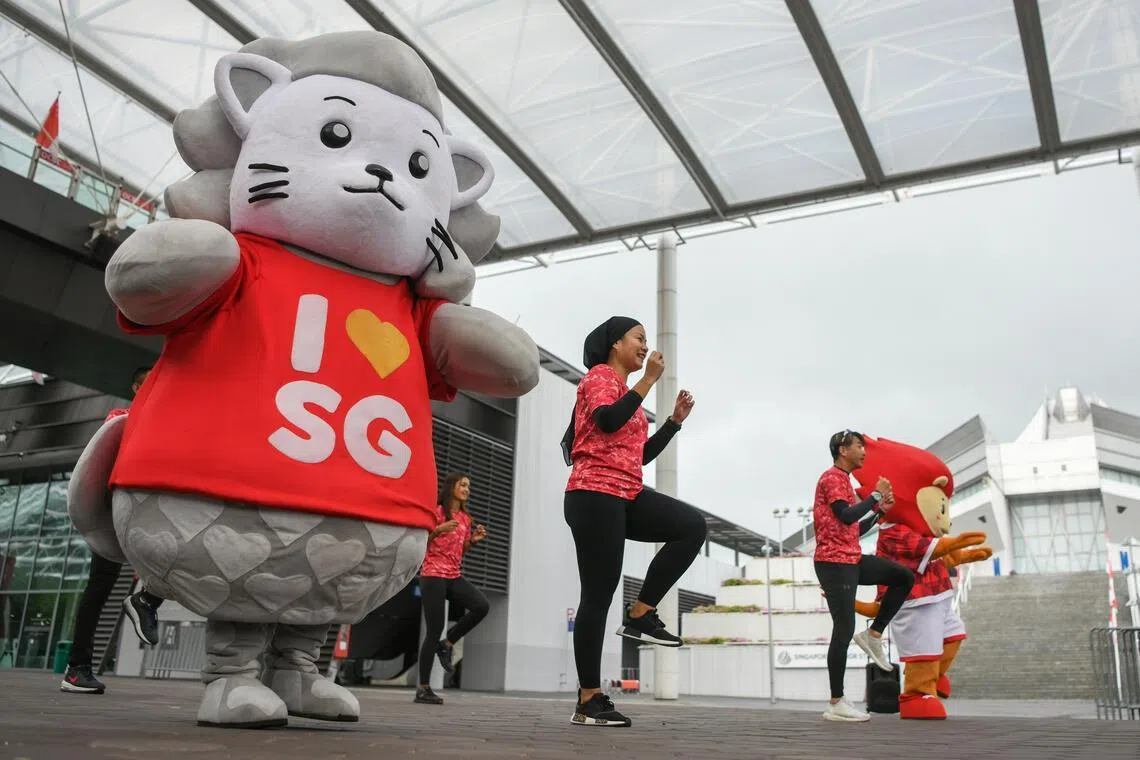 ST20230711_202377813615/nzheartlands11/Shintaro Tay/Natasha Zachariah/ 
A demonstration showing NDP mascot August (in gray) and Sport Singapore lion mascot Nila mascot (in orange), together with Team Nila volunteers, in what is known as “Dance to the Nation” at the outdoor area next to Kallang Wave Mall on July 11 to showcase what the public can expect at the NDP 2023’s GetActive! Singapore Heartland Festival. 