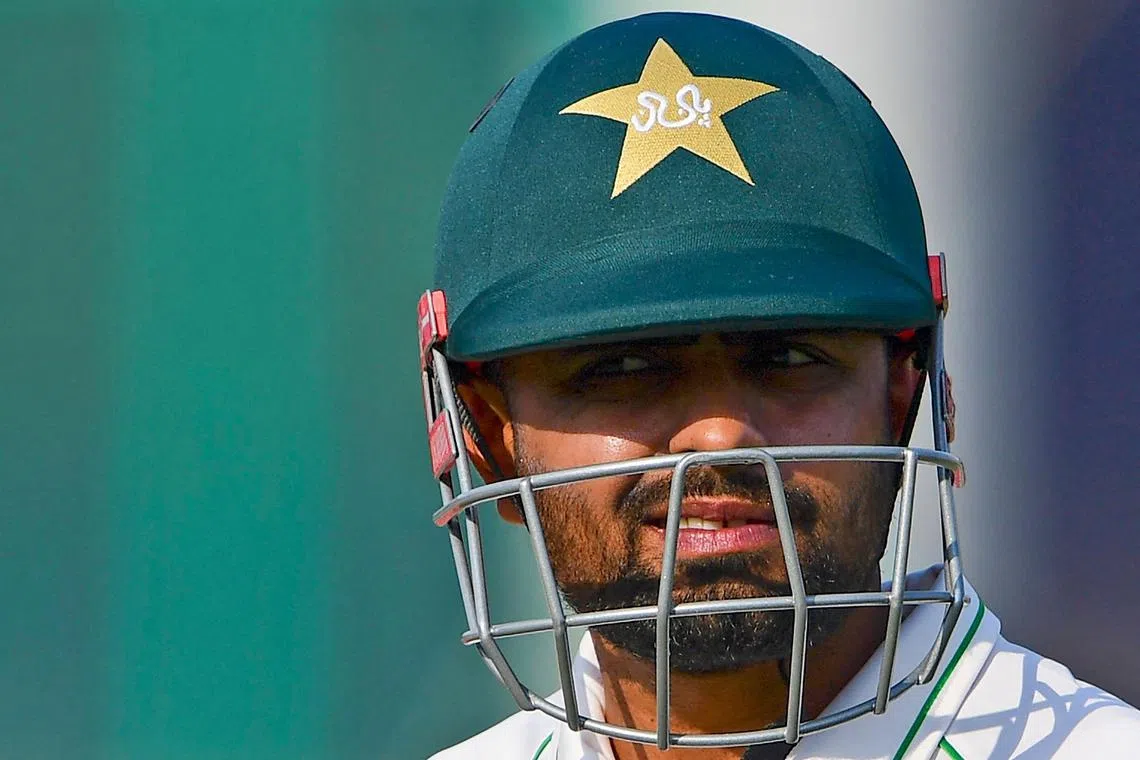 (FILES) In this file photo taken on December 27, 2022, Pakistan's Babar Azam walks back to the pavilion after his dismissal during the second day of the first cricket Test match between Pakistan and New Zealand at the National Stadium in Karachi. - Indian media is awash with articles on how Pakistan cricket captain Babar Azam was allegedly "sexting" another player's girlfriend. The problem: it's fake news that originated in a "joke" tweet from a parody account. (Photo by Asif HASSAN / AFP)