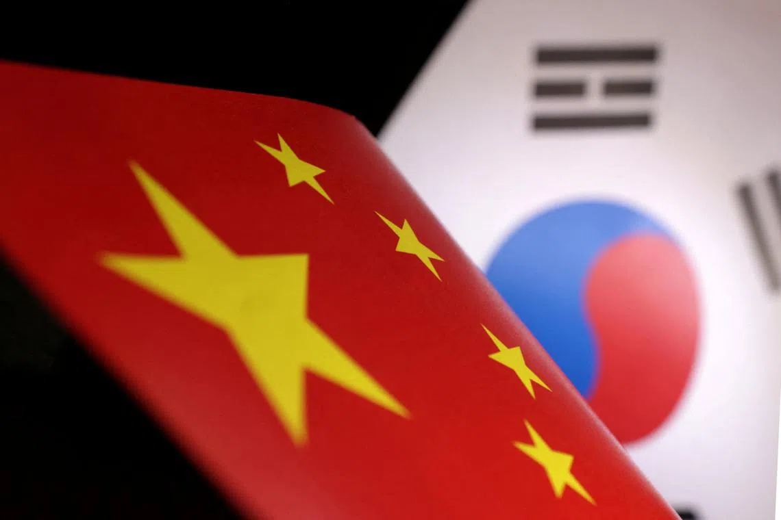 Printed Chinese and South Korean flags are seen in this illustration, July 21, 2022. REUTERS/Dado Ruvic/Illustration/ File Photo
