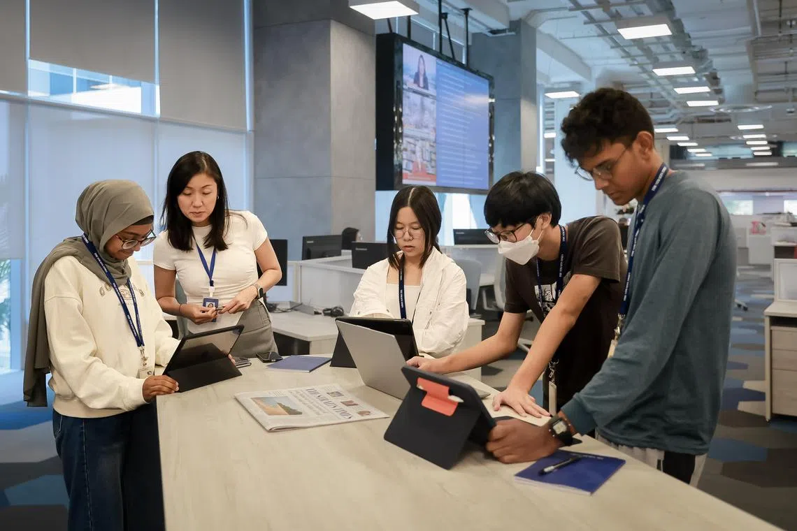 Opinion editor Lin Suling (2nd from left) debriefing Beatty Secondary School students (from left) Faahirah Binte Faizur Rahman, Wong Guan Ting, Matthew Nathaniel Kiyono Utomo and Alshaheem Noor Mohamed on their assignment at The Straits Times Newsroom, Nov 29, 2023. They were asked to pick an article of interest from The Straits Times to write a Forum letter on, and have it submitted to the Forum editor.
