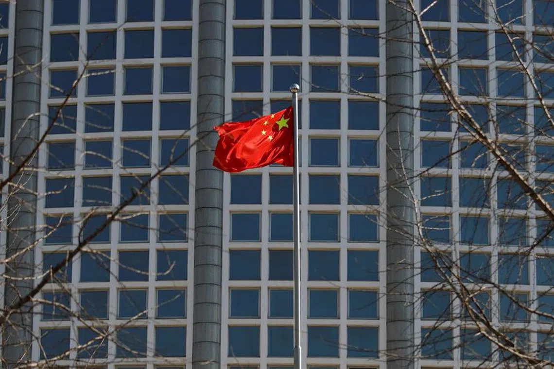 FILE PHOTO: A Chinese flag flutters outside the Chinese foreign ministry in Beijing, China February 24, 2022. REUTERS/Carlos Garcia Rawlins/File Photo