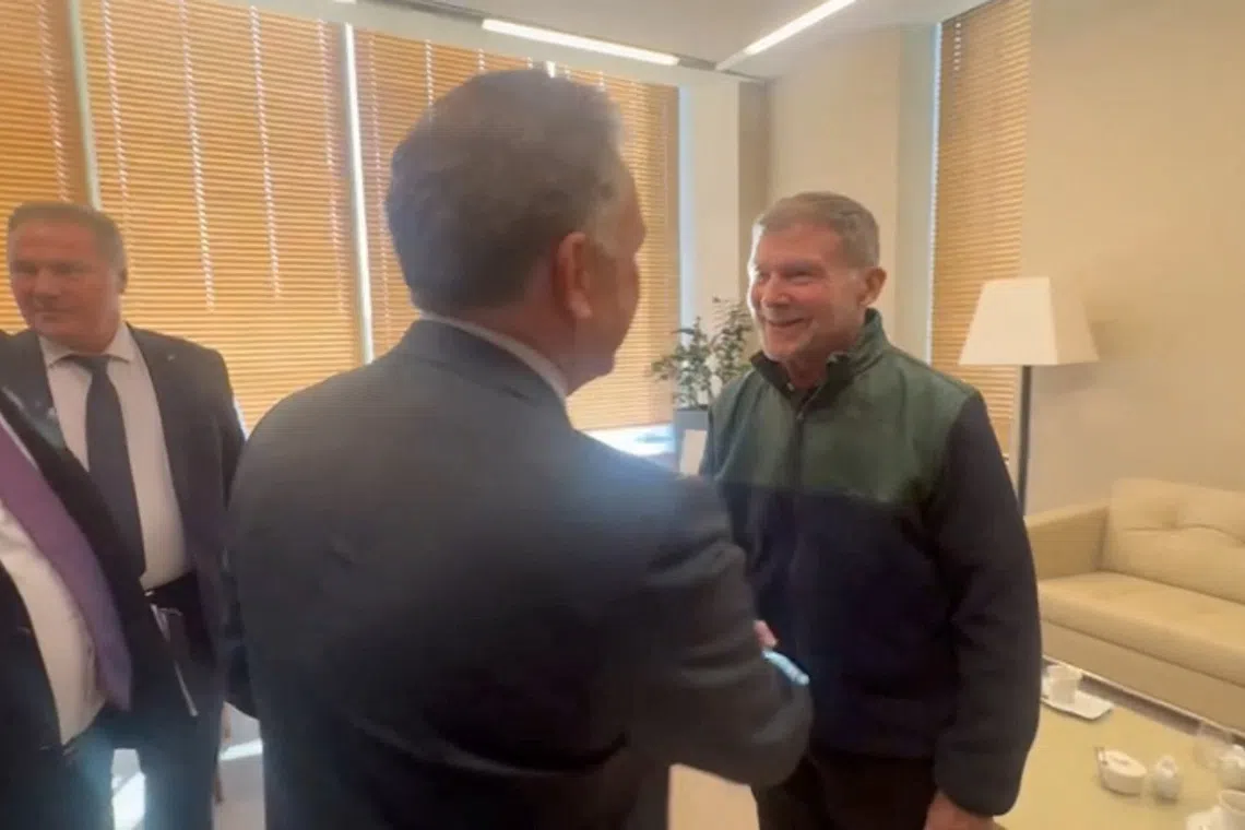 US special envoy Steve Witkoff and Russian presidential envoy Kirill Dmitriev attend a meeting with Stephen Hubbard, a 74-year-old retired U.S. schoolteacher who was recently freed after serving a prison sentence in Russia following his conviction on mercenary charges, in Saint Petersburg, Russia, October 21, 2026, in this still image taken from video. Obtained by Reuters/Handout via REUTERS